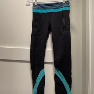 Lululemon black leggings with teal detailing. Size 4.